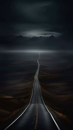 an empty road in the middle of nowhere at night with dark clouds and mountains behind it