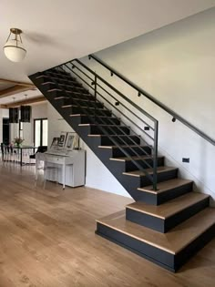 an open floor plan with stairs leading up to the upper level