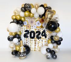 a new year's eve celebration with balloons and confetti in the shape of a wreath