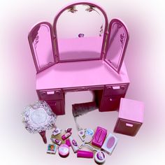 a pink doll's dressing table with accessories