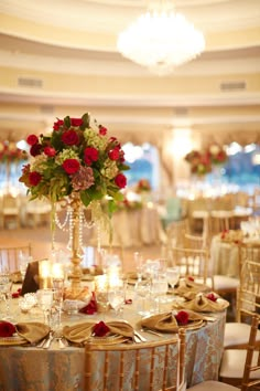 an image of a table set up with flowers and candles for a wedding reception in the ballroom