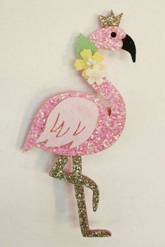 a pink flamingo with a crown on it's head and flowers in its beak