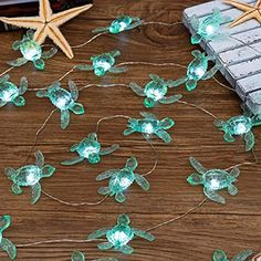 the string lights are green and have starfishs on them