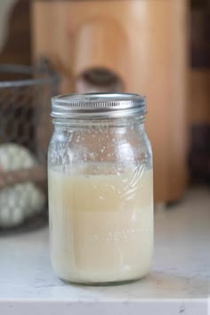 a glass jar filled with liquid sitting on top of a counter