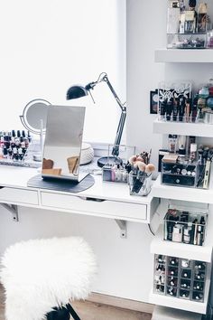 a white desk topped with lots of bottles and drawers