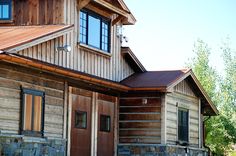 an old log house with stone and wood sidings