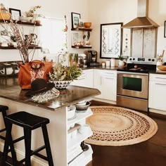 a kitchen filled with lots of counter top space and decor on the wall above it