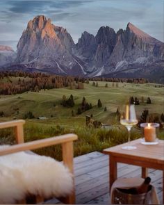 the mountains are in the distance and there is a table with two chairs on it