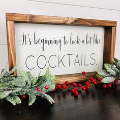 a wooden sign that says it's beginning to look at the cocktails