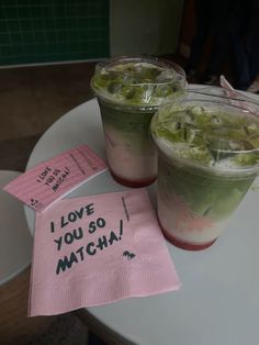 two cups of ice tea on a table with a note that says i love you so matcha