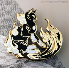 "The Bakeneko is one of the 12 hard enamel pins from the Shiny Fantasy set from Kickstarter ! Product details : Size of the pins : 2' Material : Hard Enamel gold plated pin On the back, you'll find 2 butterfly clutches for fixing the pins everywhere.  The pins is send with its backing card \"Shiny Fantasy\" (9x7 cm). This collectible pin will be perfect on your bags, clothes etc. Don't wait ! It's a limited edition !" Cat Enamel Pin, Pretty Pins, Magical Jewelry, Pin Art, Backing Card, Cat Brooch, Metal Pins