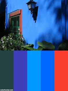 a blue house with red shutters and a light fixture on the side, in color swatches