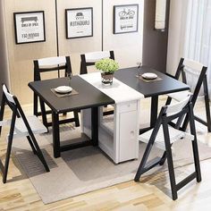 a black and white dining table with four chairs