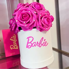 pink roses in a white box with the word barbie on it