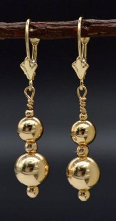 These new 14k solid yellow gold round 8mm lever back bead dangle earrings are classically styled with smooth and sensational shiny round 8mm beads for a design that won't fade out with time. The hanging length is 1.5". Product Details These earrings sway with playful movement and shine. High Polished 14K Solid Gold 8mm & 6mm Total Hanging Length of Earring from top to bottom is 1.5 inches. Gold Round Faceted Beads Earrings, 14k Yellow Gold Earrings With Round Beads, Artisan Yellow Round Bead Earrings, Nickel-free Yellow Gold Round Bead Earrings, Gold Crystal Earrings With Nickel-free Round Beads, Beaded Dangle Earrings, Etsy Earrings Dangle, Beaded Dangles, Solid Gold