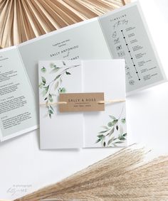 the wedding stationery is laid out on top of each other