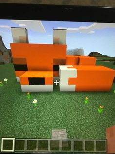 a computer screen with an orange couch in front of it