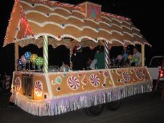 an elaborately decorated vehicle with lights and decorations on it's roof is driving down the street