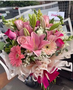 a bouquet of pink flowers sitting on top of a table