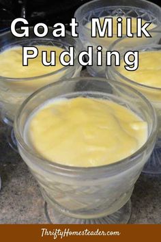 four glasses filled with pudding sitting on top of a counter