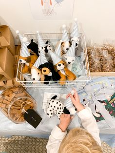 a little boy is playing with stuffed animals