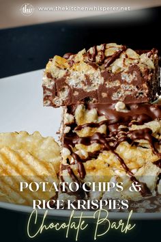 a white plate topped with pieces of chocolate covered dessert next to crackers and chips