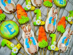 some decorated cookies with carrots and bunny ears on top of each other, including one for the letter e