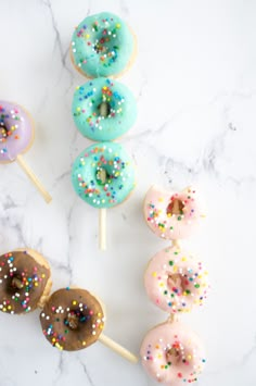 donuts with sprinkles on them are lined up next to each other