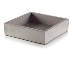 a square concrete box with no lid on a white surface, viewed from the front