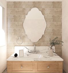 a bathroom with marble counter tops and a large mirror on the wall above it's sink