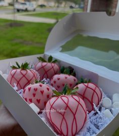 a box filled with pink chocolate covered strawberries