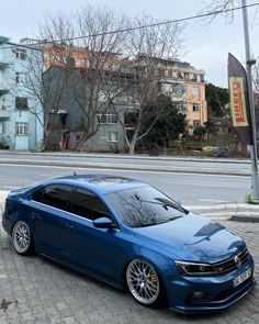 the blue car is parked on the side of the road