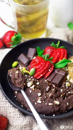 chocolate cake with strawberries and nuts on a plate