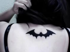 a woman with a bat tattoo on her back