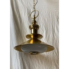 an old fashioned light hanging from a ceiling