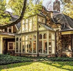 a large house with lots of windows in the front yard