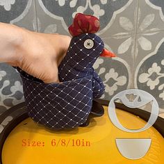 a person holding a chicken on top of a yellow tray next to a white and black tile wall