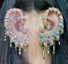 a close up of a person with ear piercings on their ears and behind the ear