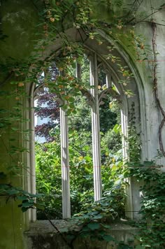 an old building with ivy growing on it's walls and windows in the middle