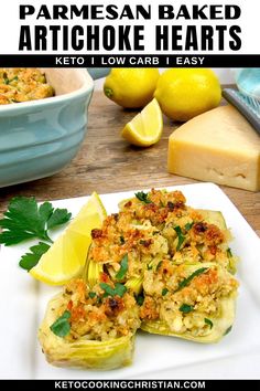 baked artichoke hearts on a plate with lemons and parmesan