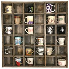 a wooden shelf filled with lots of coffee cups