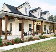 a white house with porches and rocking chairs