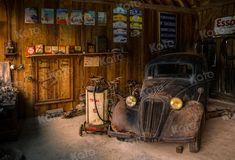 an old car in a garage with gas pumps on the floor and wood paneled walls