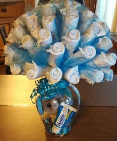 a vase filled with lots of diapers on top of a table