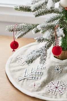 a small christmas tree with ornaments on it