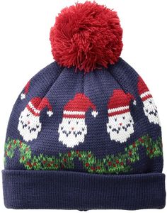 a blue knitted hat with skulls and santa hats on the front, red pom - pom