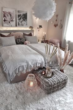 a white bed sitting in a bedroom on top of a fluffy rug next to a window