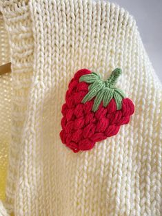 a knitted sweater with a strawberry on it