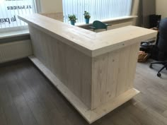 a wooden counter sitting in front of a window