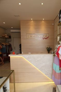 the front desk of a clothing store with clothes on display